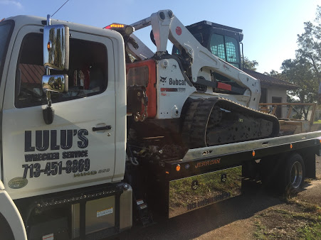 A white truck with a crane on the back of it